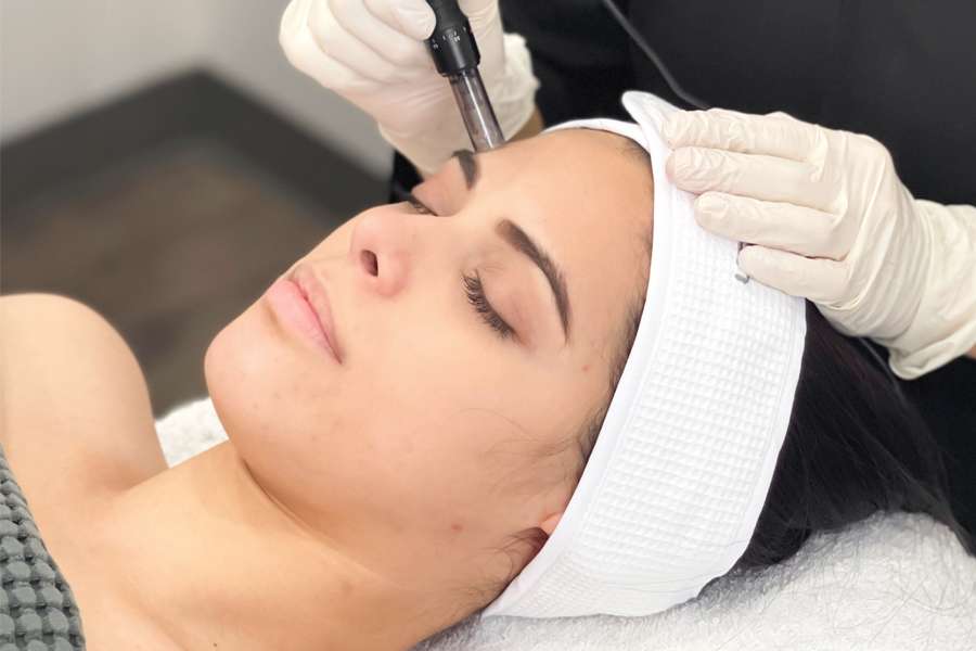 woman with eyes closed receiving a mesotherapy treatment