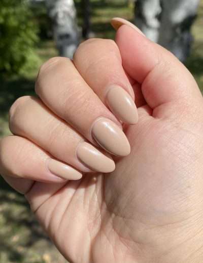Closed fist with beige manicured nails