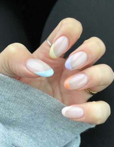 French tip manicured nails with a different colour on each nail tip