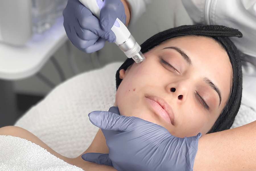 Woman receiving hydradermabrasion facial treatment in Winnipeg