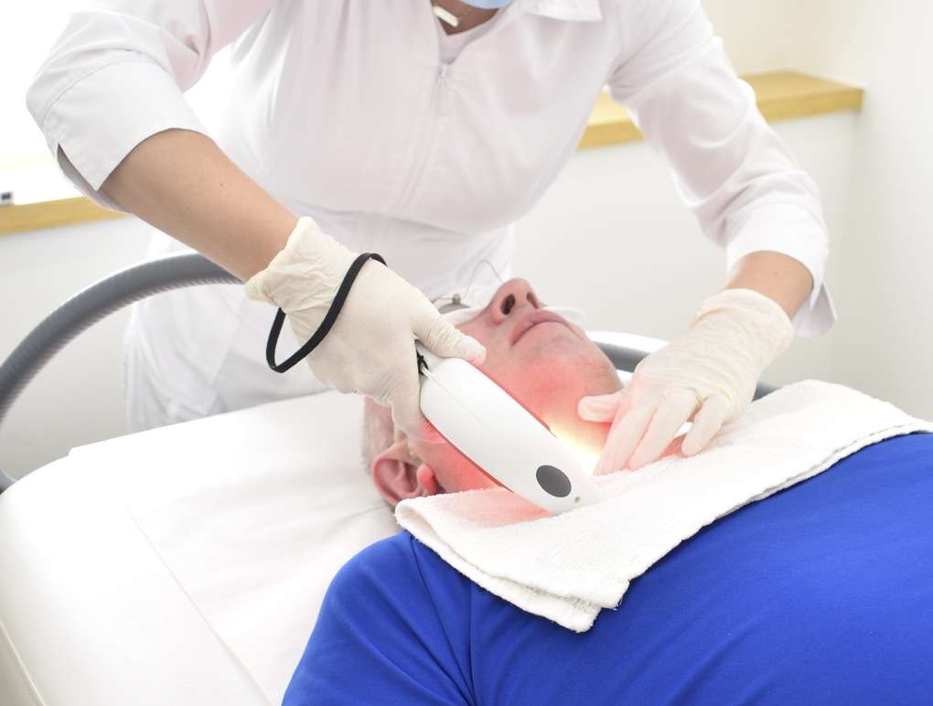 facial laser hair removal service on client