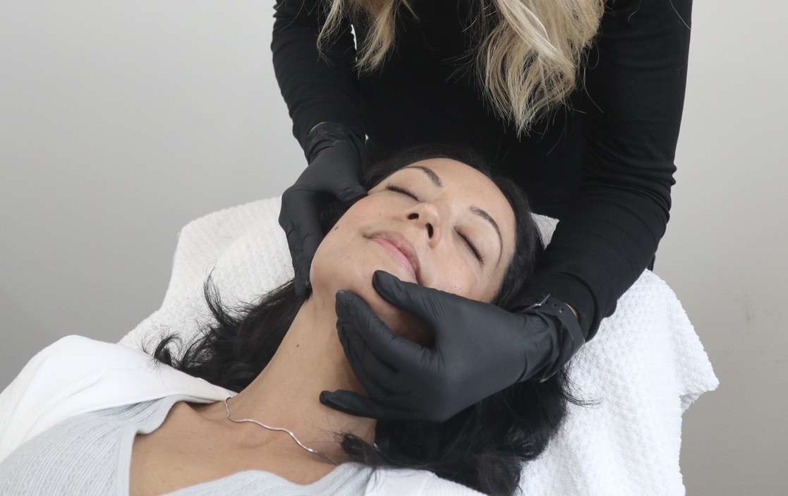 Client getting her skin checked at Total Wrapture medi Spa.