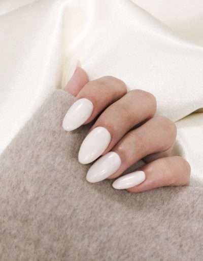 Shellac manicured nails on client showing light coloured nails.