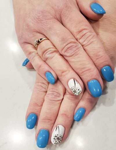 Blue manicured nails with white design