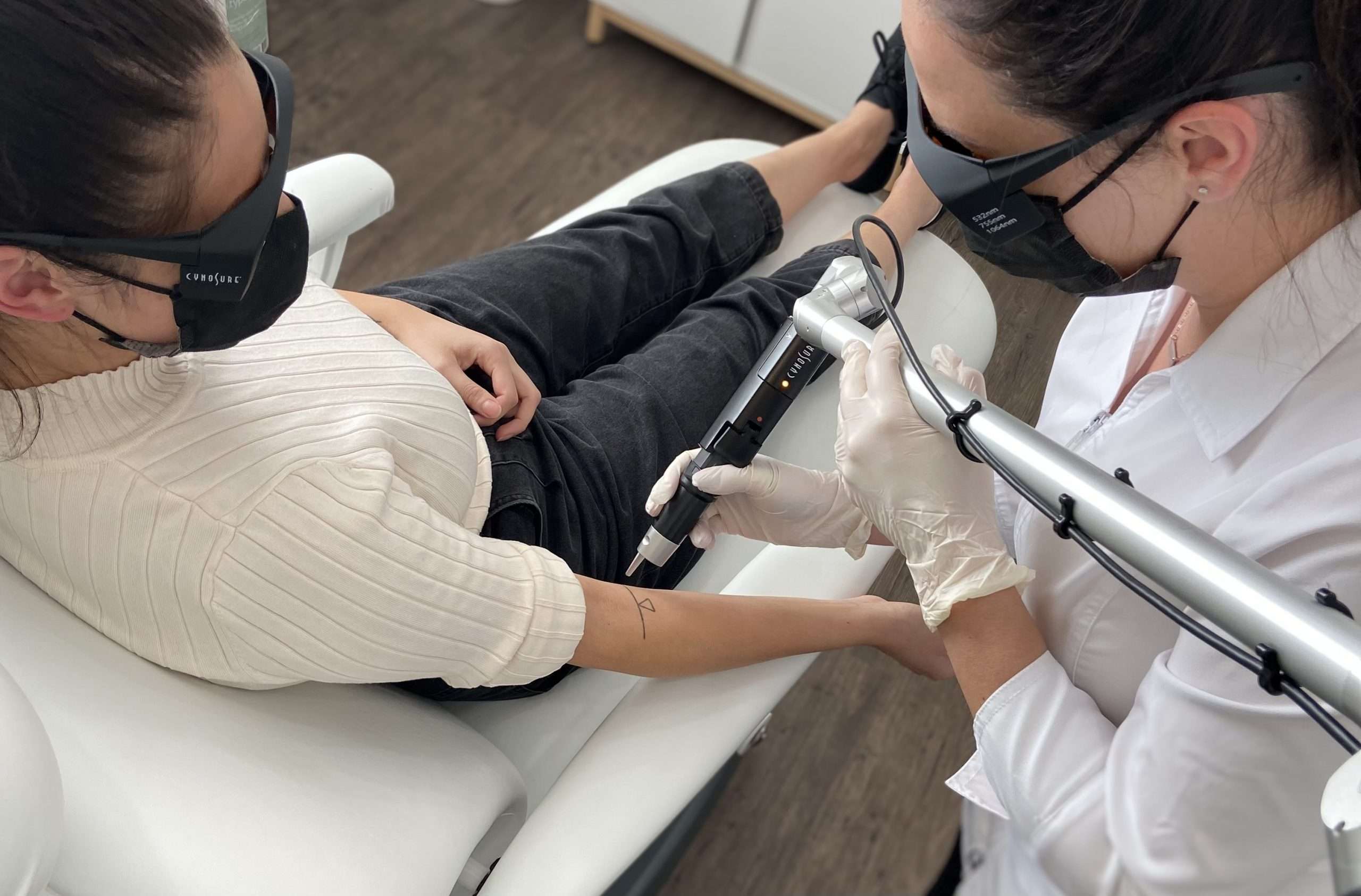 laser tattoo removal on client's arm.