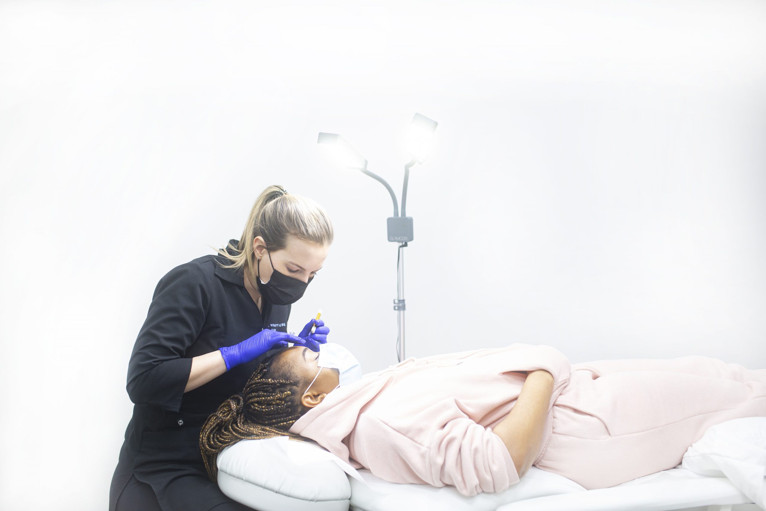 Total Wrapture Medi Spa esthetician performing a microblading service.