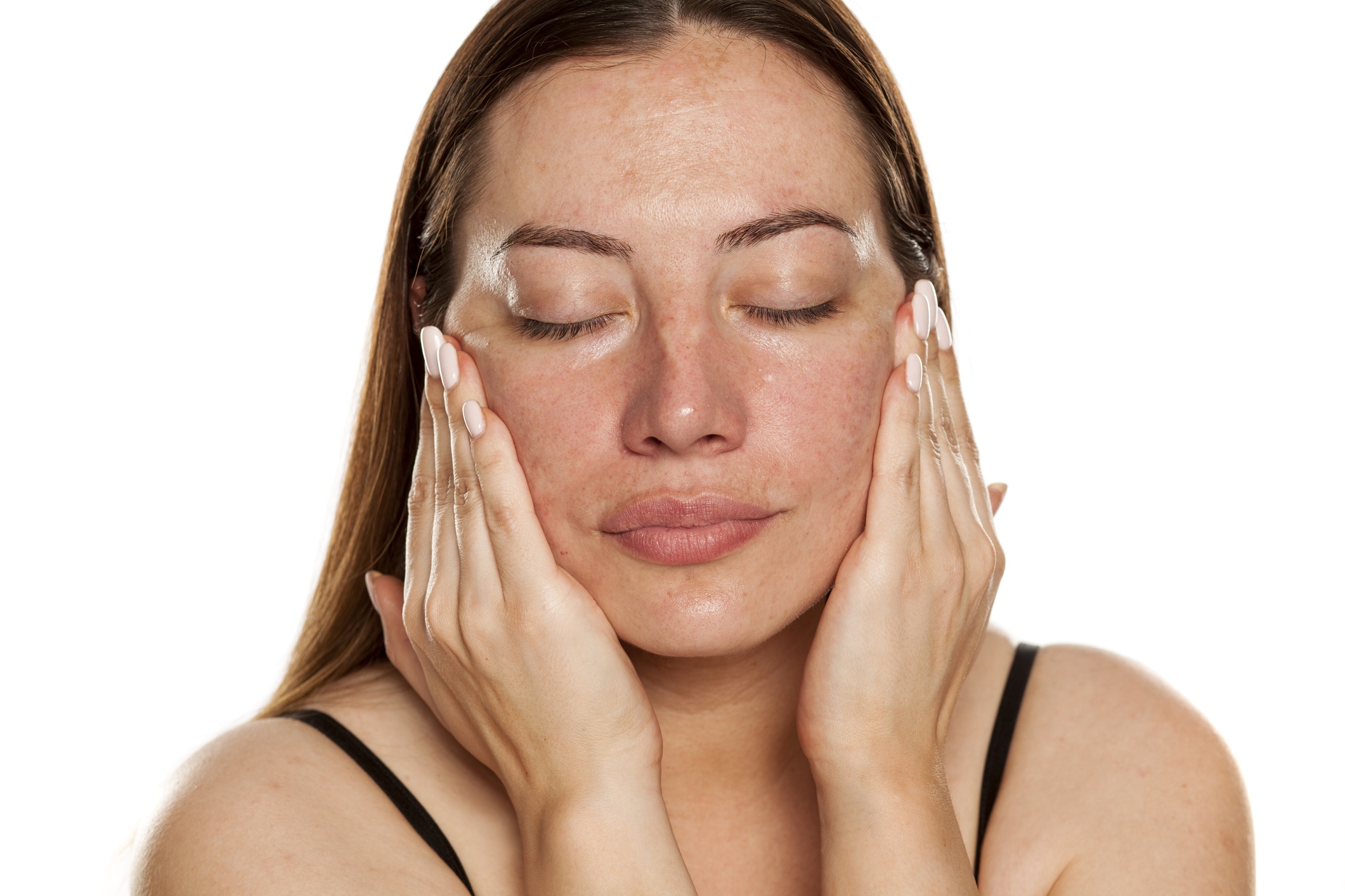 woman applying moisturizer on her face