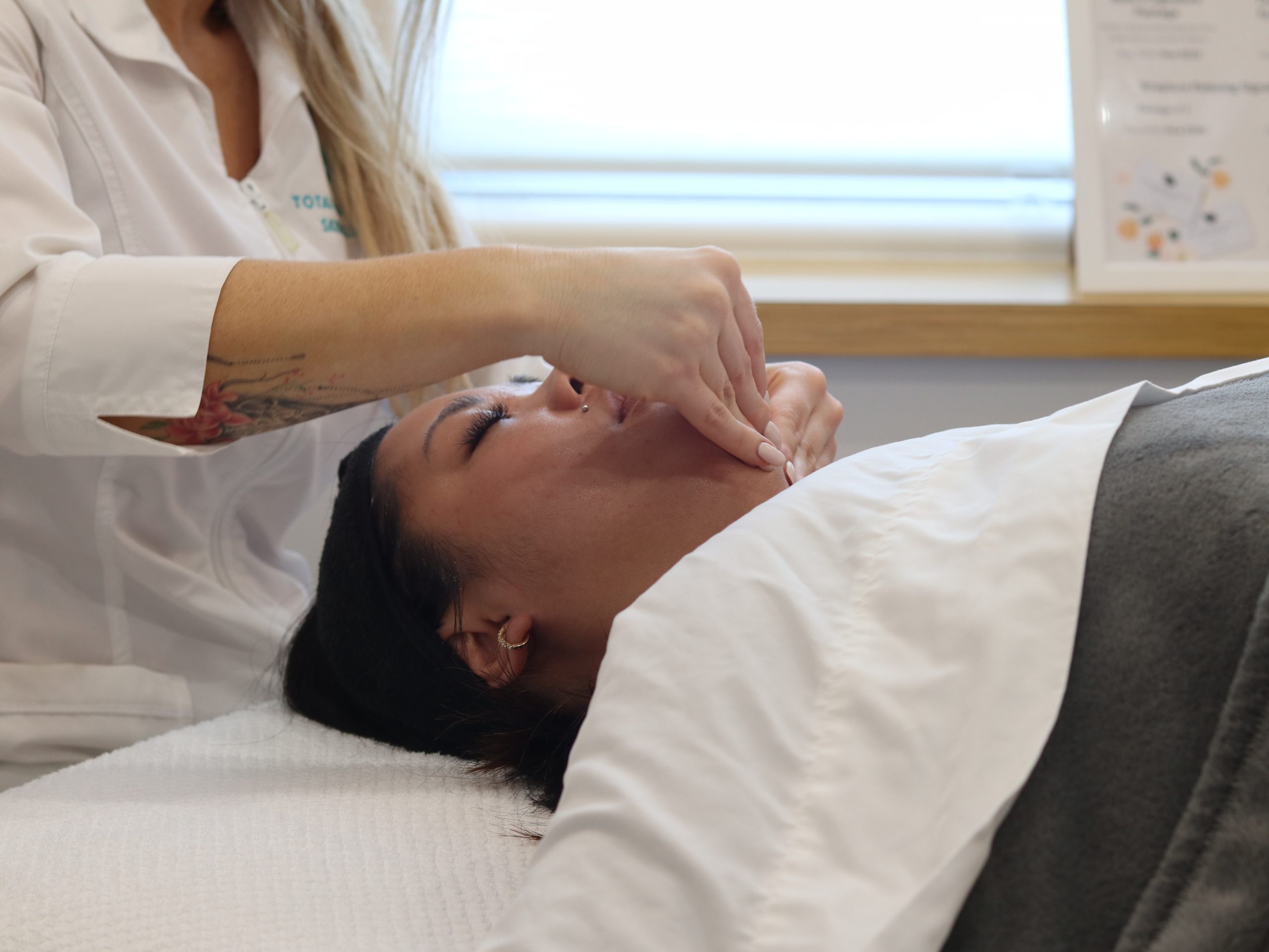 client getting a facial massage