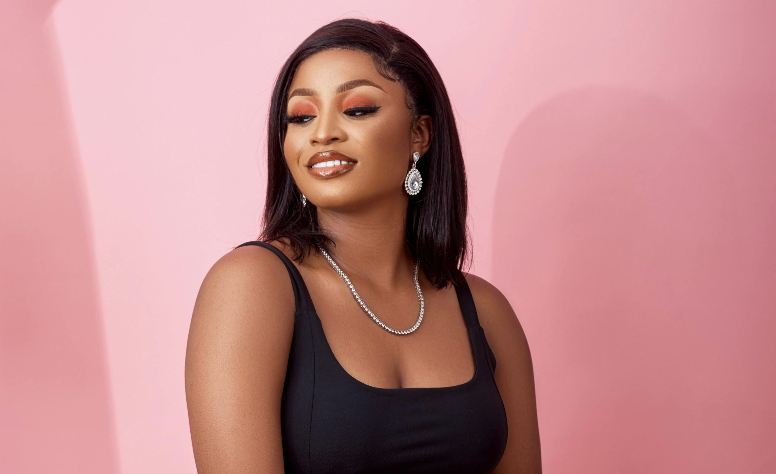 a person who presents as female in formal attire and firm skin after spa treatments Winnipeg