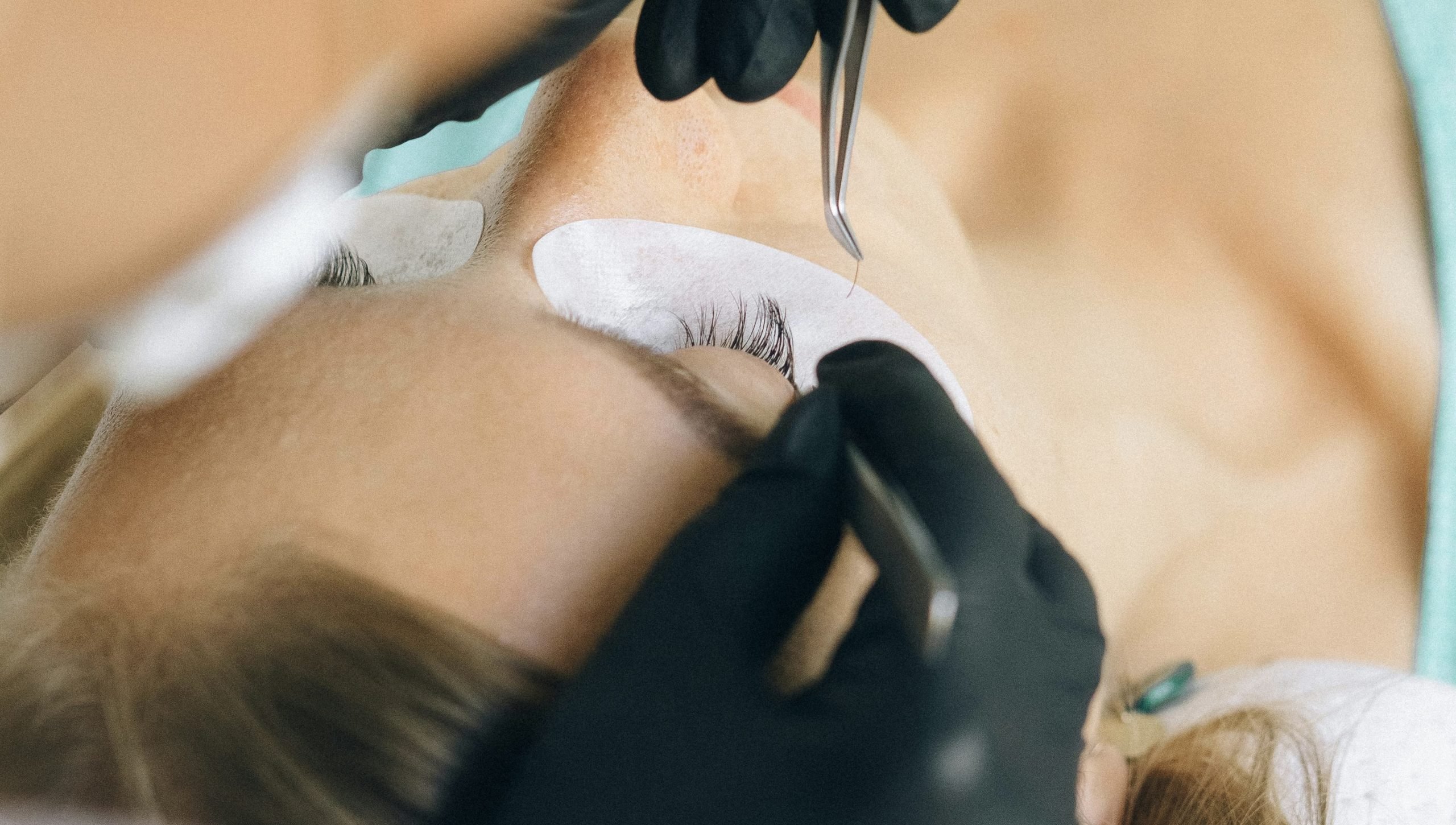 Lash artist in Winnipeg performing a detailed lash extension service on a client