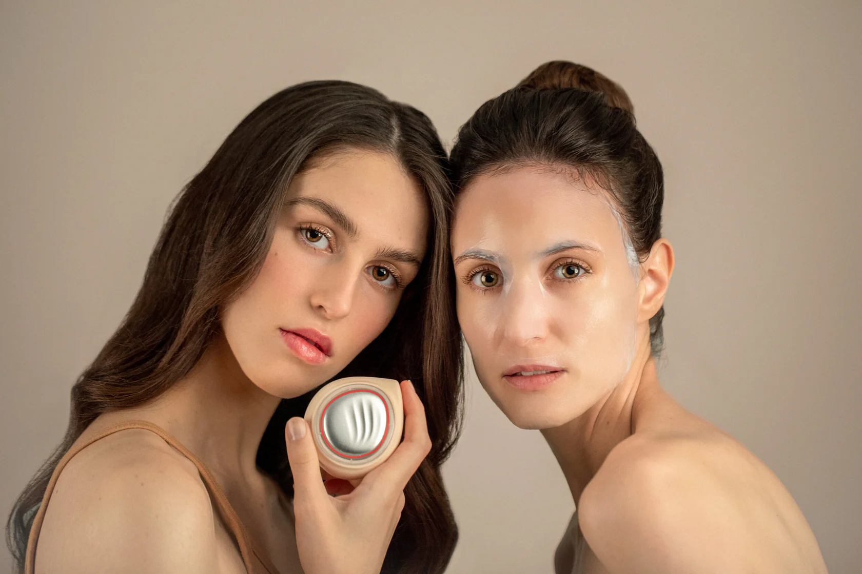 two persons modelling a hadaka light therapy device