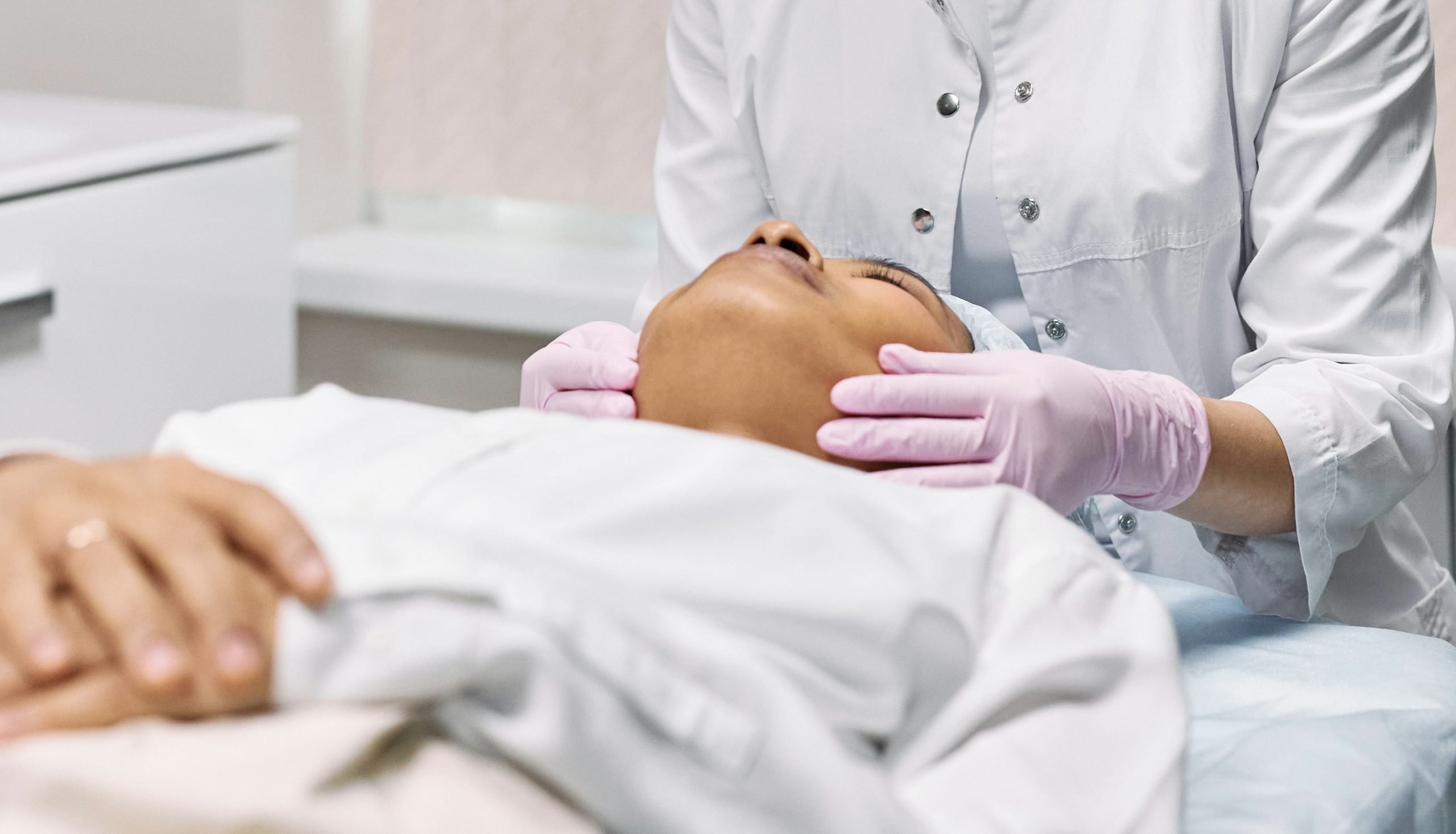 Skin specialist in winnipeg examining a client's skin