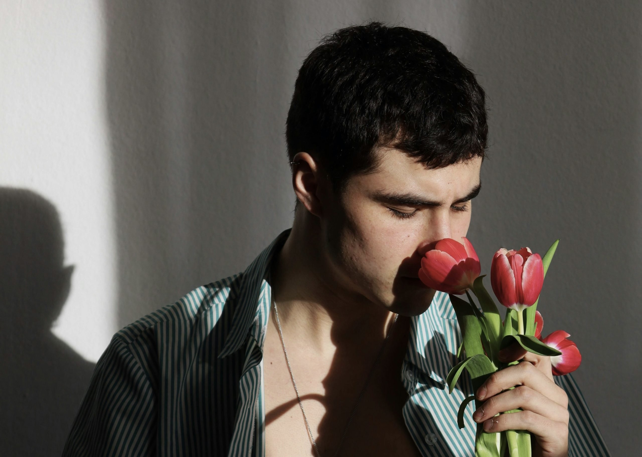 A man smelling flowers