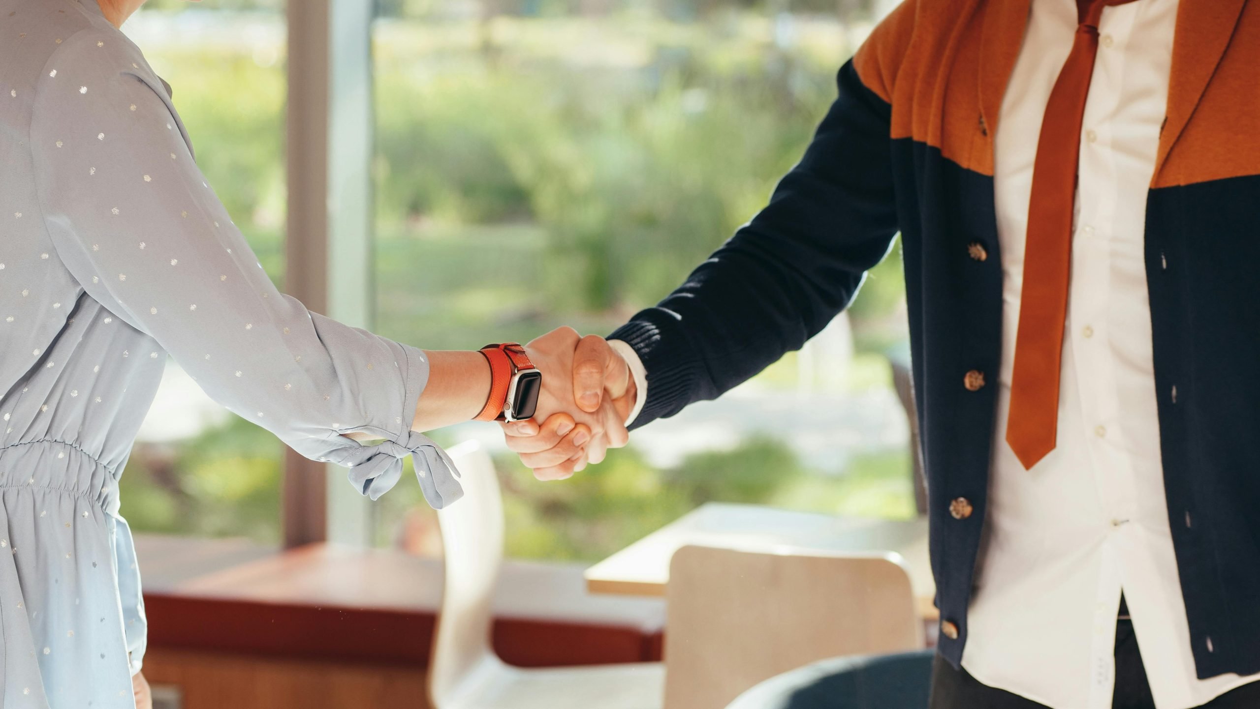 a close-up shot of a handshake. One of the hands has obviously received a men's manicure in winnipeg