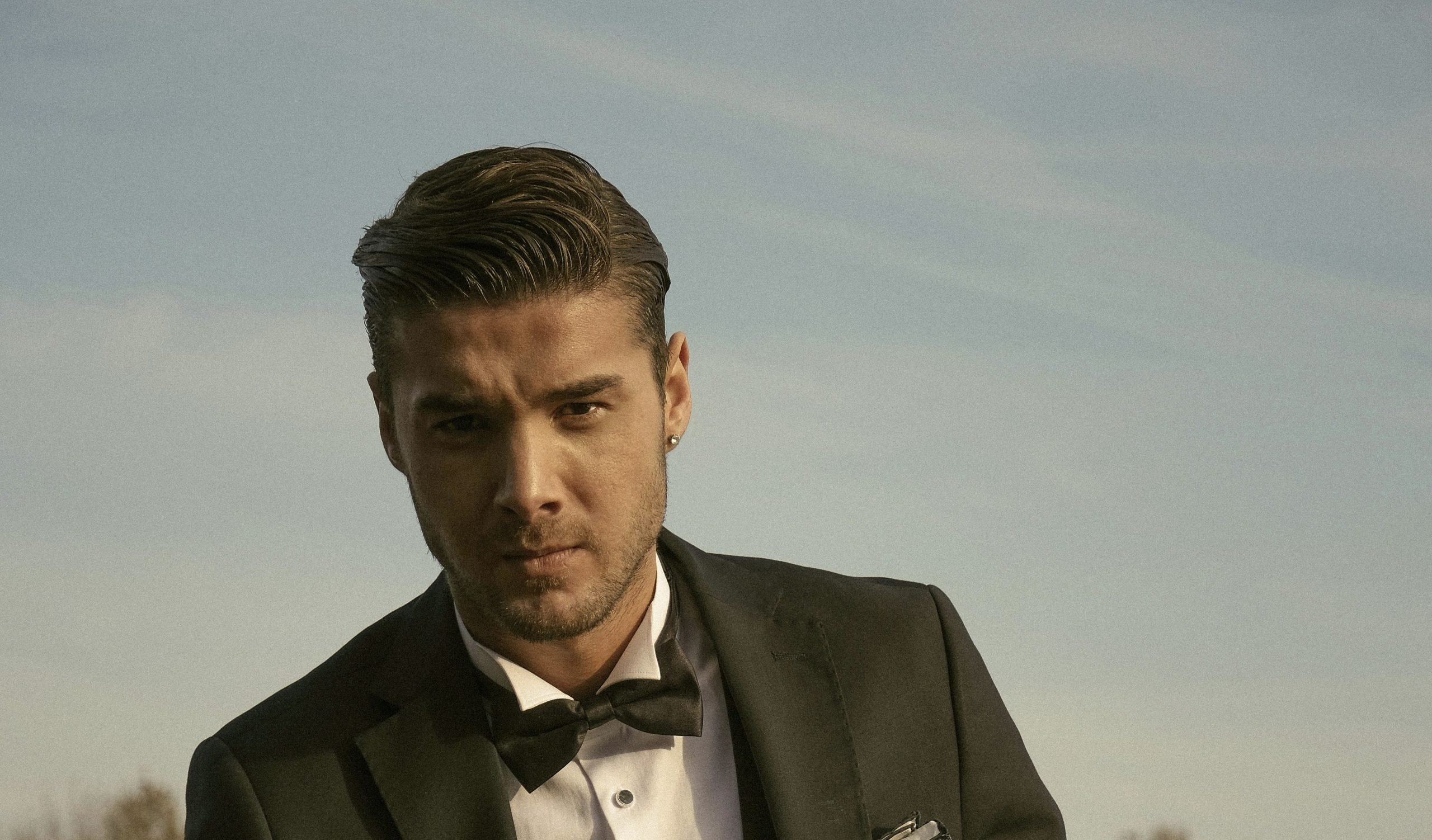 A man in a bowtie who looks like he has gotten a Men’s Manicure and Pedicure