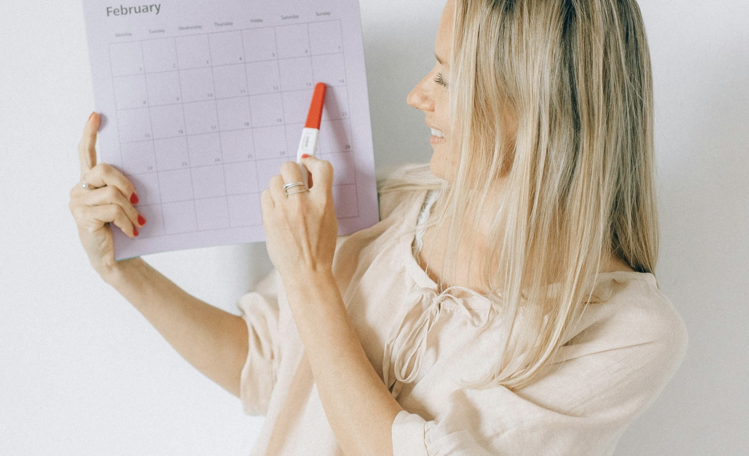 woman looking at a calendar to see when to pause her active ingredients before her chemical peel in winnipeg